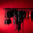 thumbnail sexual toys hanging rack against red background