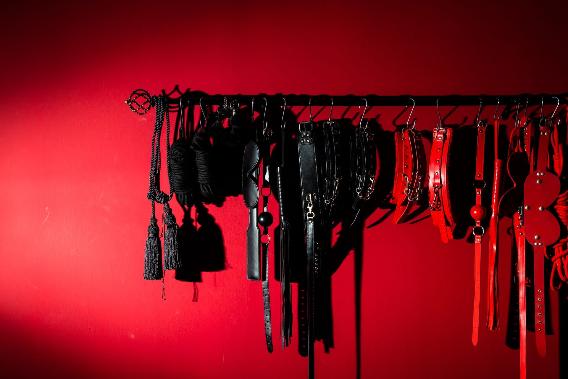 thumbnail sexual toys hanging rack against red background